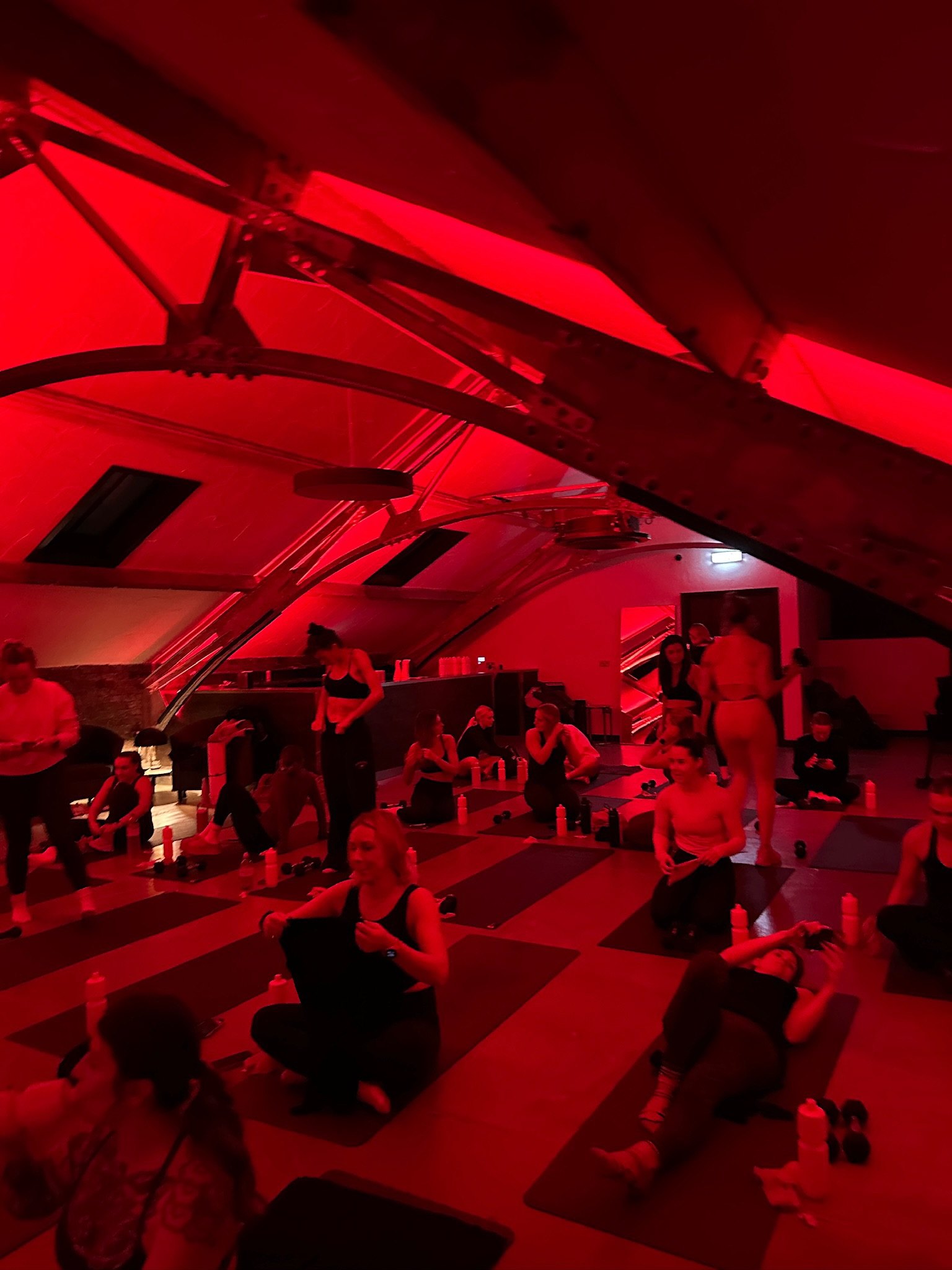 People gathered for an event under red light at Harbour House